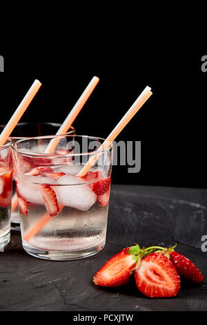 Strawberry detox water. Summer iced drink. Lemonade with berry. Flavored Water in glasses with Fresh Strawberry.  Diet. Stock Photo