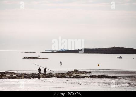 View of sea activities as the sun goes down at Rhosneigr beach, Traeth Cridyll, Anglesey, North Wales, UK Stock Photo