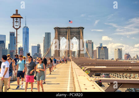 June 10, 2017.  New York City, New York.  Tourists and Traffic on the brooklyn bridge and the new york city skyline on a sunny day in the summertime. Stock Photo