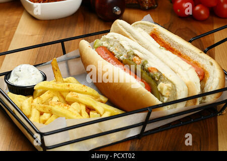 Gourmet Grilled All Beef Hots Dogs with Sides and Chips Stock Photo