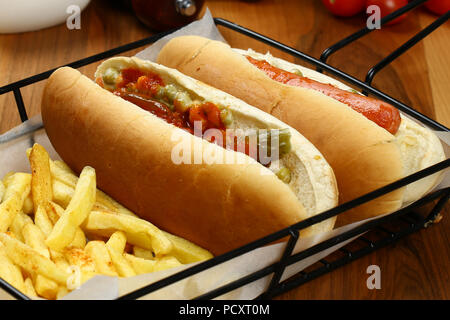 Gourmet Grilled All Beef Hots Dogs with Sides and Chips Stock Photo