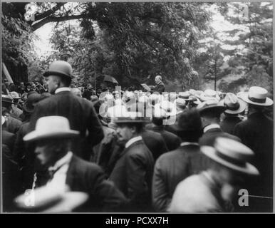 Alton Brooks Parker, 1852-1926, half length, standing, facing left; making speech to large group of men Stock Photo