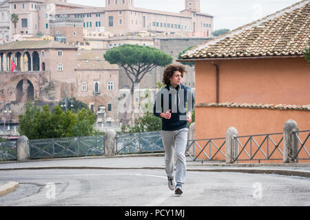 Handsome young sportsman jogging in Rome city Stock Photo