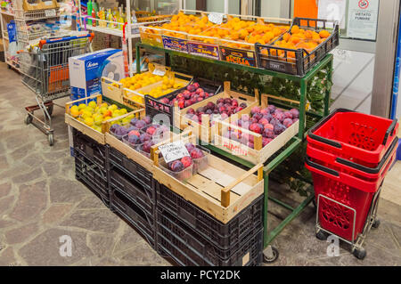 Display of fruits with apricots, apples and plums in front of a supermarket in the town of Igea Marina in Italy Stock Photo