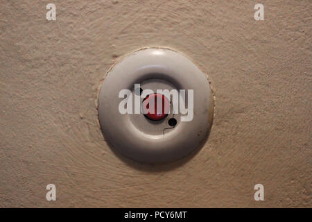 Old round light switch in residential building staircase. Stock Photo