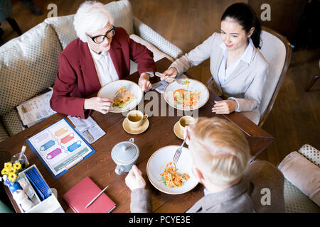 People having dinner after work Stock Photo