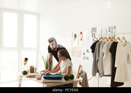 Designers team discuss new collection in ethnic showroom Stock Photo
