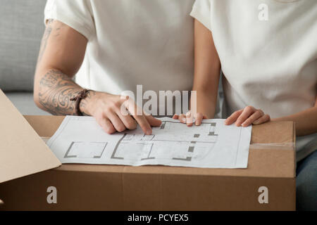 Close up of couple discussing blueprint planning flat renovation Stock Photo