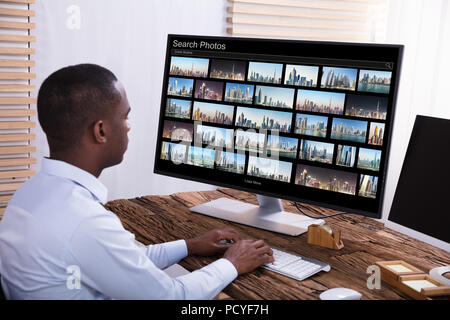 Close-up Of A Male Photo Editor Editing Images On Computer At Workplace Stock Photo