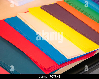 Close-up cropped image of pen and files with keyboard and spectacles on wooden office desk Stock Photo