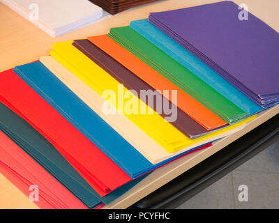 Close-up cropped image of pen and files with keyboard and spectacles on wooden office desk Stock Photo