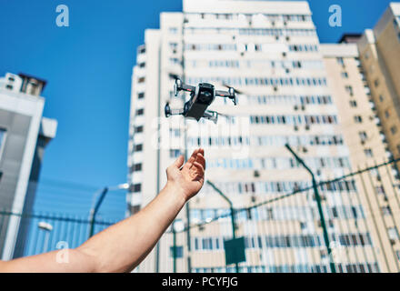 man launches quadcopter Stock Photo