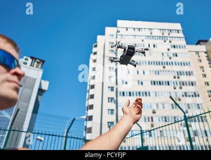 man launches quadcopter Stock Photo