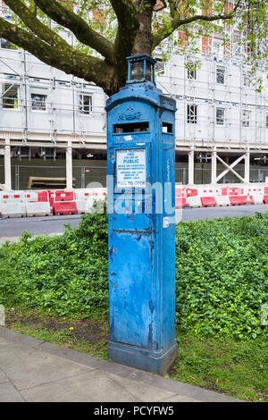 A blue police telephone box in London, UK Stock Photo