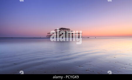 The ruins of the West Pier in Brighton at sunset and a low spring tide Stock Photo
