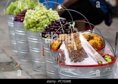 metallic buckets with dried fruit for selling in a mexican market, coconut, pear, peach, fig Stock Photo