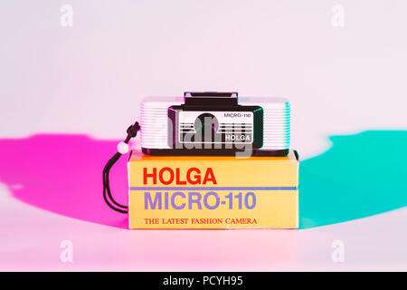 CHONBURI, THAILAND - August, 2018 : Holga micro 110 camera and the box, Used color plate cover flash for pink and soft blue color shade. Stock Photo