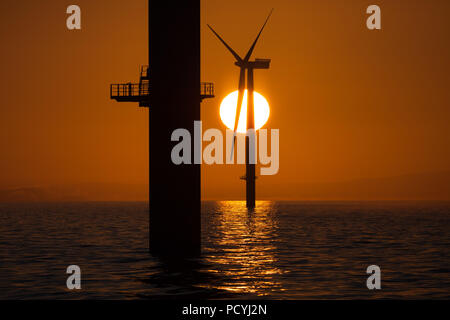 Sunrise over offshore wind turbines on Walney Offshore Wind Farm in the Irish Sea, UK Stock Photo