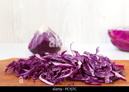 Chopped red cabbage on cutting board, closeup. Side view. Stock Photo