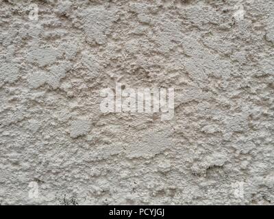 rough stucco cover clad on masonry brick wall. light pink colour rough old concrete wall. Stock Photo