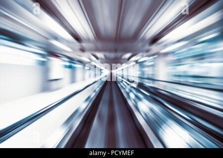 Motion blur abstract background, fast moving walkway or travelator in airport terminal transit, zoom effect, center diminishing perspective Stock Photo