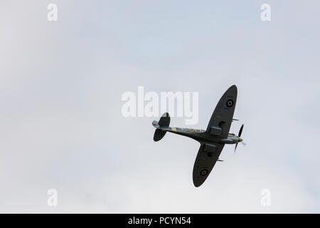 Underside view of a historic RAF Spitfire aeroplane in flight Stock Photo