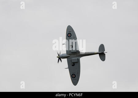 Underside view of a historic RAF Spitfire aeroplane in flight Stock Photo