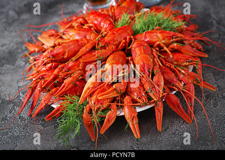 Crayfish. Red boiled crawfishes on table in rustic style, closeup. Lobster closeup. Border design Stock Photo