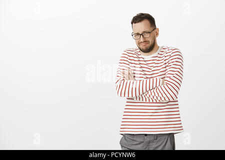 Boyfriend dumped me on our anniversary. Portrait of miserable crying caucasian gay model in glasses, crossing hands on chest and whining, complaining  Stock Photo