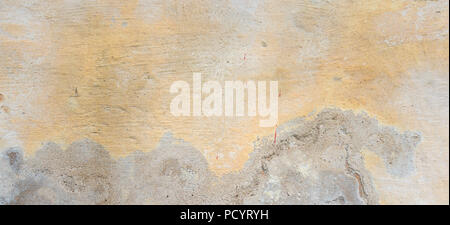 Textured grunge background. Old plastered wall with a multilayer cracked coating. Grunge texture with a deep pattern on yellow wall Stock Photo