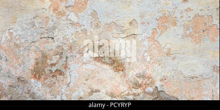 Textured grunge background. Old plastered wall with a multilayer cracked coating. Grunge texture with a deep pattern on whitewashed wall Stock Photo