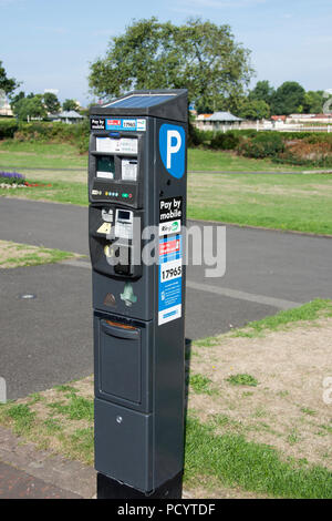 Parking signs and machines on streets of Southport Stock Photo