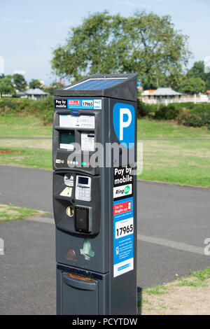 Parking signs and machines on streets of Southport Stock Photo