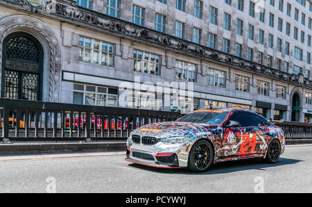 5 August 2018 - London, England. Powerful BMW M4 car wrapped in colorful vinyl participating in Gumball Rally 3000 event. Stock Photo