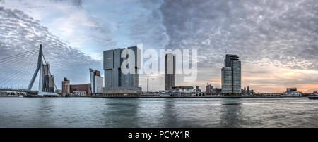 Rotterdam, The Netherlands, November 11, 2015: Panoramic view of Erasmusbridge and Kop van Zuid area on the southbank under a spectacular sky Stock Photo