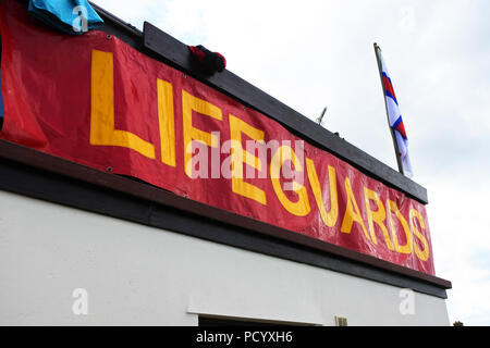 Lifeguard sign on the side of a building, Marazion, Cornwall, UK - John Gollop Stock Photo