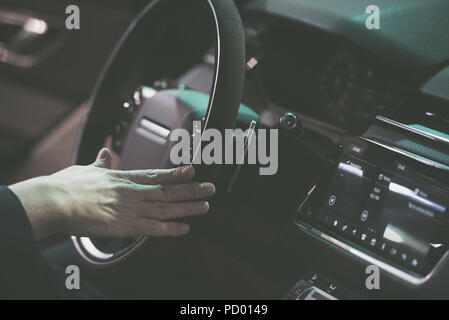 Man hand on a steering wheel of a modern car Stock Photo