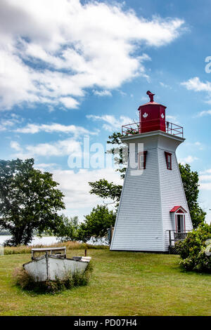 White framed, red trimmed square tapered Wrights Range Lighthouse and Lobster Boat at Victory-by-the-Sea; Prince Edward Island (PEI), Canada CA). Stock Photo