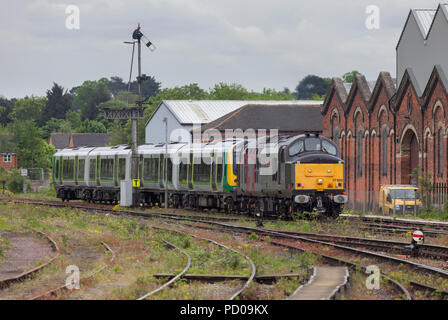 A Europhoenix class 37 locomotive operated by Rail Operations group at  Worcester Shrub Hill hauling a West Midlands railway train after repair. Stock Photo