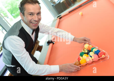 businessman holding billiard balls Stock Photo