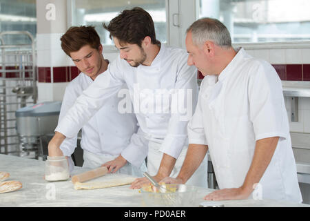 apprentice in bakery trying to make pretzels Stock Photo