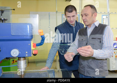 young male engineer in factory using milling machine Stock Photo