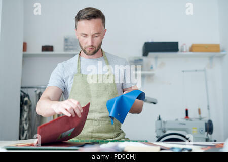Clothier working in workshop Stock Photo