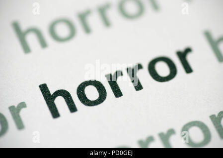 word horror printed on white paper macro Stock Photo
