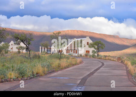 South Africa, a fantastic travel destination to experience third and first world together. Karoo cottages in Karoo national park. Stormy sky. Stock Photo