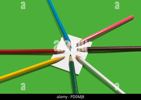 note and colorful pencils lying on it Stock Photo