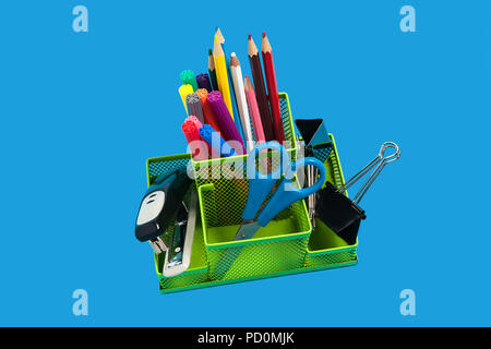 green empty pencil holder on an orange surface Stock Photo