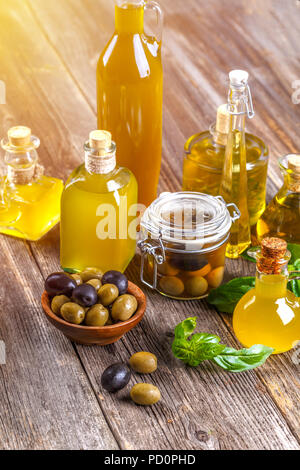 Bottles of extra virgin olive oil and olive berries Stock Photo