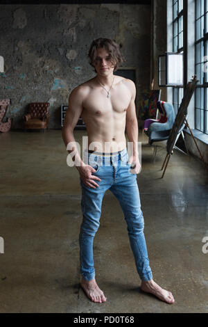 Handsome blond male model with blue eyes full body posing indoors Stock Photo