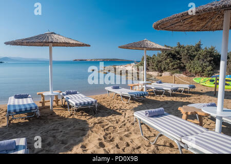 Umbrellas with sunbeds on beautiful sandy Santa Maria beach with turquoise sea water, Paros island, Greece Stock Photo